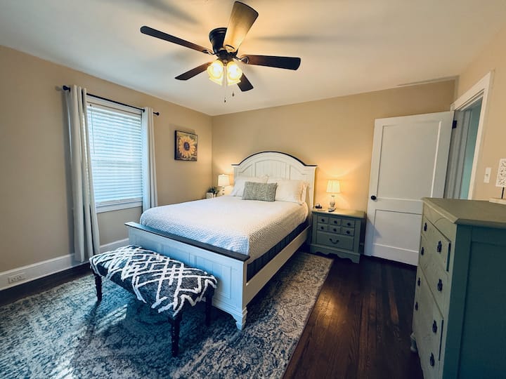 1st Floor Queen bedroom with bathroom next door. Ceiling and box fan, closet, smart TV, nightstands and charging ports.