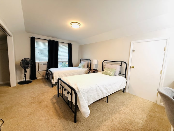 Second Floor bedroom with twin beds, a desk and smart TV.