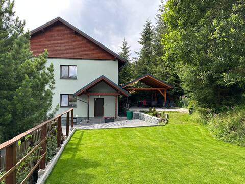 A log cabin with a fireplace and beautiful surroundings