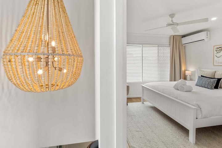 Spacious master bedroom featuring a comfortable queen sized bed