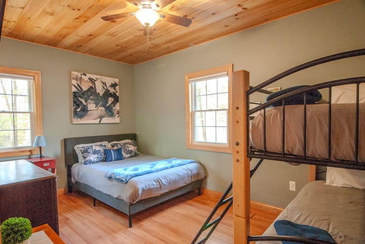The third bedroom features a queen bed, two twin bunk beds, room-darkening shades, and a Roku TV. A private desk overlooking Christmas Mountain makes this an ideal spot for remote work or a quiet creative escape. Bed linens and towels are included.