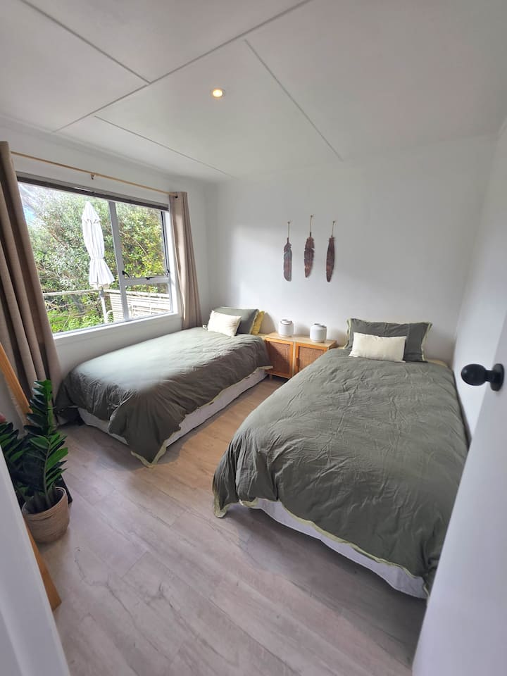 Main bedroom configured as two comfortable and generous-sized king single beds.
