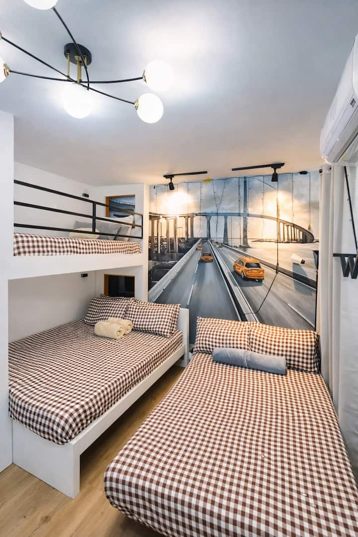 This is the setup of the beds if you book 4-5guests. 

1 on the top bunk (single/twin size), 
2 on the bottom bunk (queen size),
2 on the sofabed with foam on top so it's comfortable sleeping (double/full/family size) 