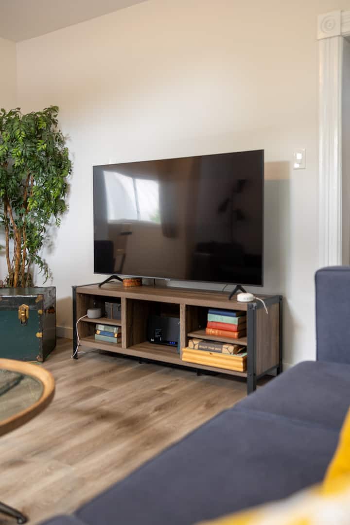 Cozy living room with large TV, stylish console, and inviting seating