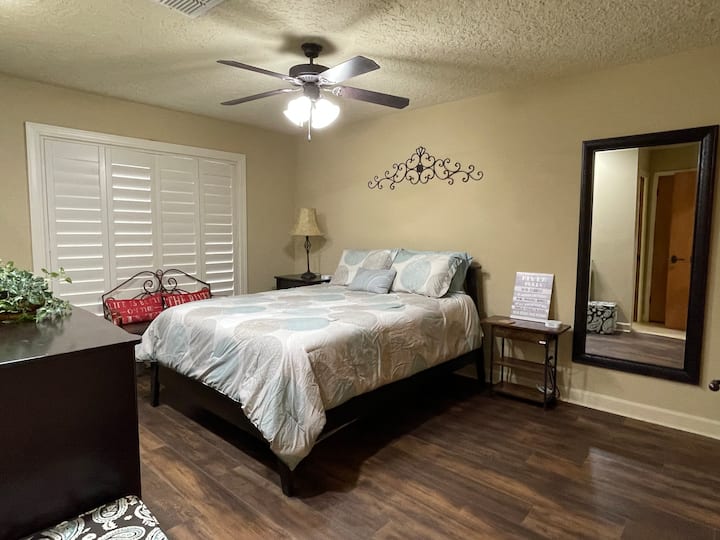 Master bedroom has queen size bed and includes a TV.