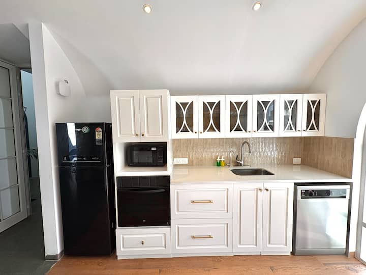 Designed for comfort and functionality, this white European-style kitchen features modern appliances