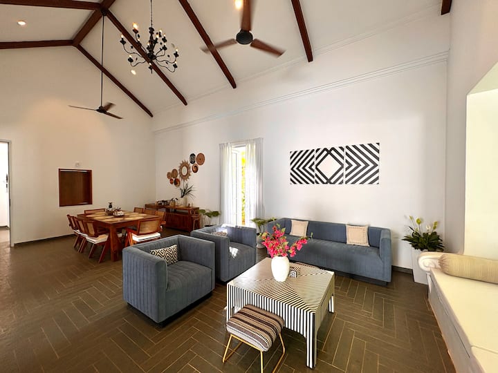An airy, light-filled Santorini-style living room with elegant décor, spacious comfort, soft neutral