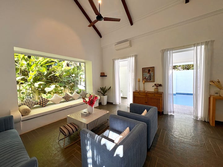 This stunning Santorini-inspired living room is spacious, aesthetically styled, and designed for com