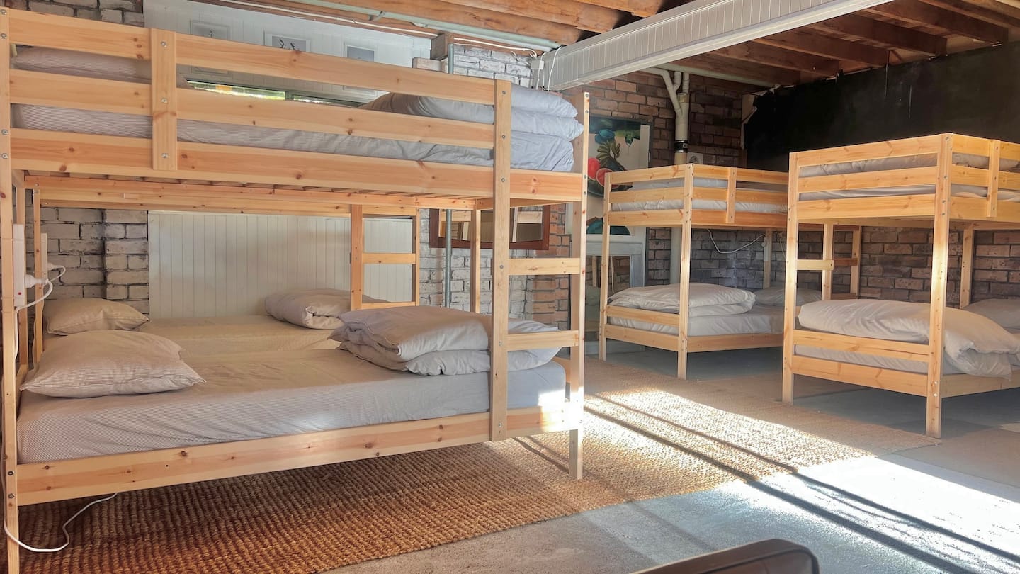 Downstairs dorm with four sets of timber bunk beds