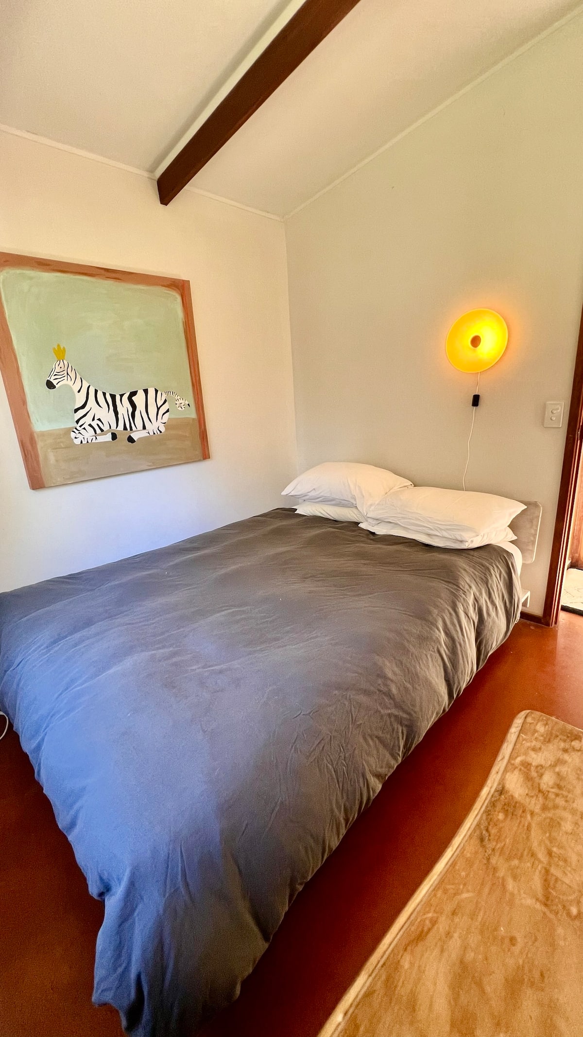 Queen bed with bedside lamp