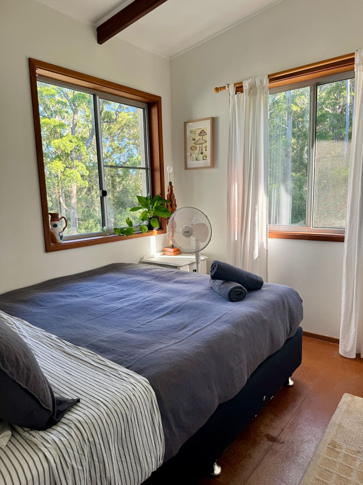 Queen bedroom with windows looking into the trees