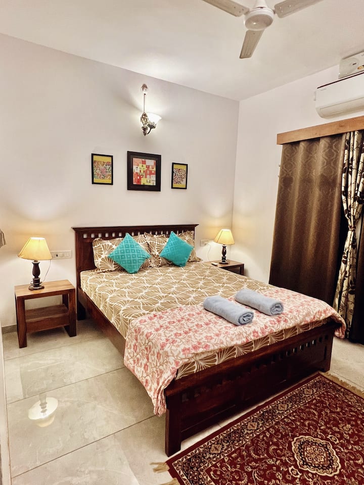 Elegant bedroom designed with a comfortable bed, side tables & table lamps. 6 inch spring mattress, soft pillows, clean cotton sheets & AC quilt ensure a good nights sleep! Attached balcony ensures amazing views right from the bed!