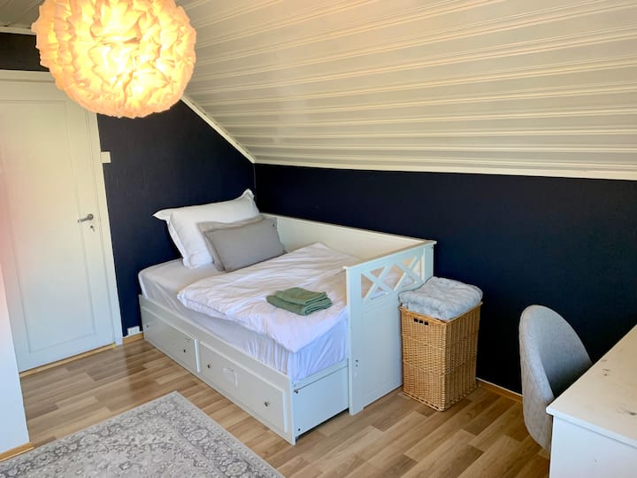 Letto 120x200, scrivania e ampio spazio nell'armadio con una finestra che si affaccia sul giardino