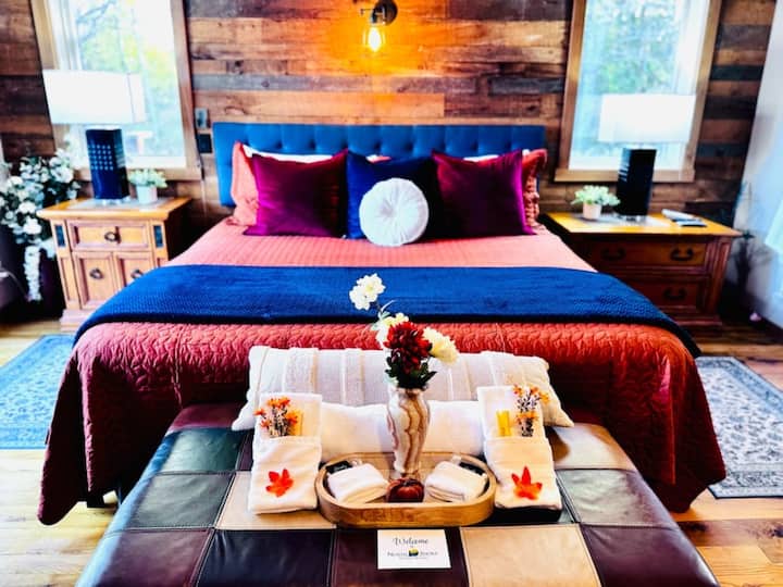 Duluth, MN, primary bedroom with seasonal décor, TV, and stunning views—cozy North Shore retreat with top scenery.