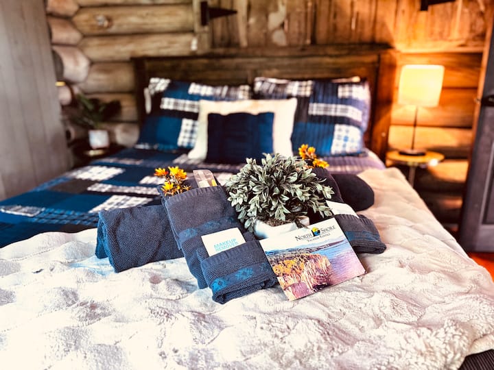 Experience a cozy night in this comfortable queen bed that overlooks the yard in front of the cabin. Enjoy the stunning colors of the autumn leaves as they drift from the trees.