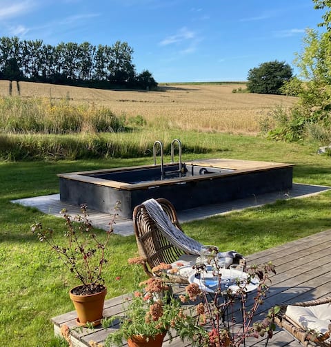 Seaside accommodation with a small pool in an open landscape