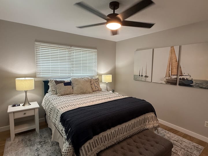 Cama queen, dormitorio en la planta baja con sábanas adicionales guardadas en el banco con espacio de almacenamiento.