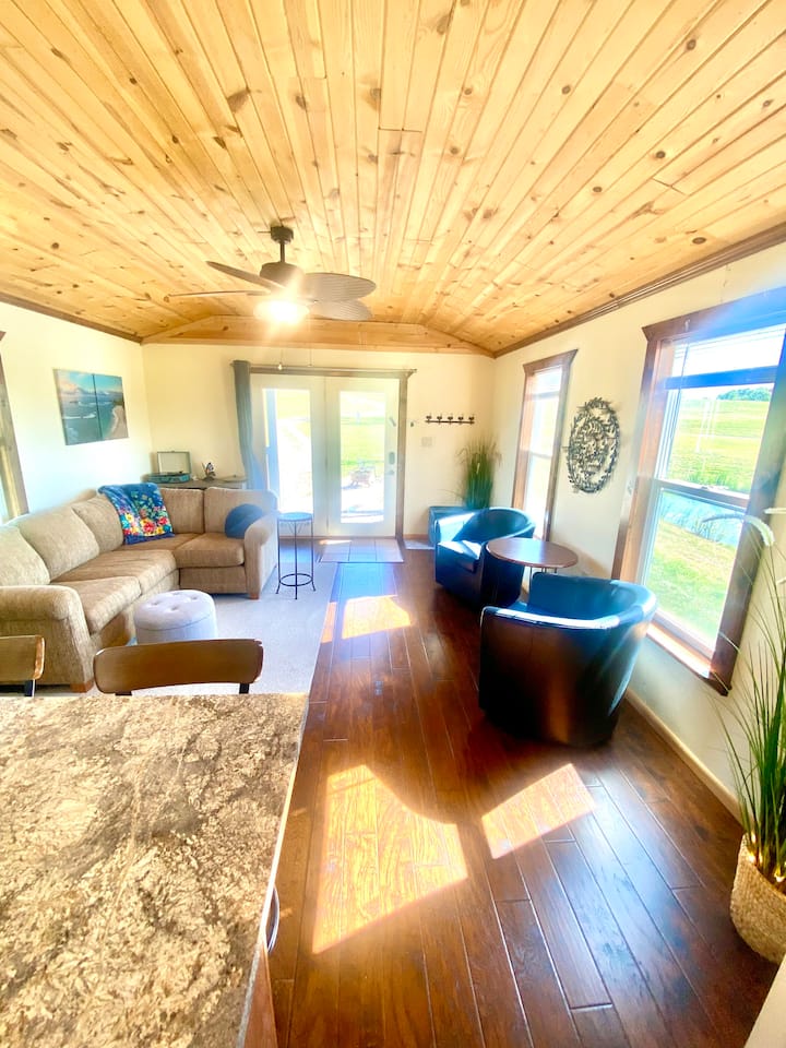 Marries cozy comfort with ample space, offering the perfect blend for relaxation.  With stunning views of the serene pond and expansive wildflower prairie, it's a tranquil haven where you can unwind while immersing yourself in the beauty of nature.