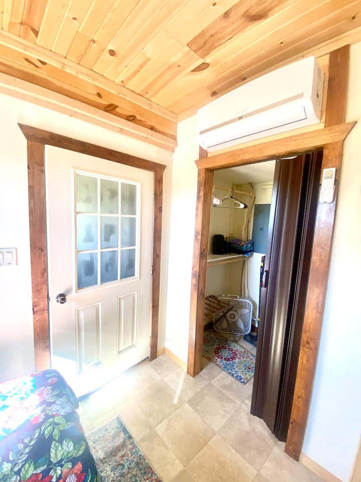 The side bedroom has a queen-size memory foam mattress with soft cotton bedding and four fluffy pillows.  It's located off the kitchenette and bathroom.  It has a walk-in closet and a mini-split unit for cooling and heating.