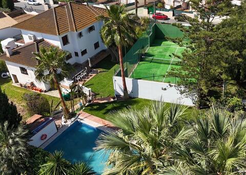 House with a paddle tennis court and private pool