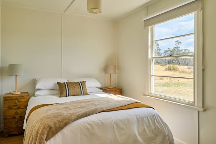 Master bedroom with queen sized bed overlooking the river