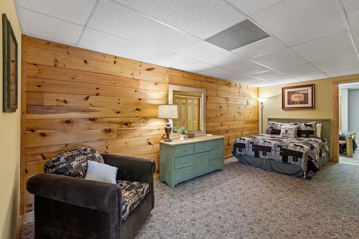 Lower level queen bedroom that has an En Suite attached full bathroom with double sinks.  Door to bedroom number 4 is pictured to the right of the bed.  Currently that is the way the people staying in that room enter and exit.