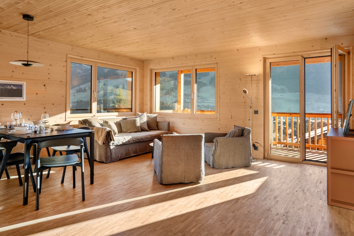 Disfruta de la sala de estar abierta con vistas panorámicas a las montañas y mucha luz natural. Perfecto para noches relajantes y comidas compartidas.