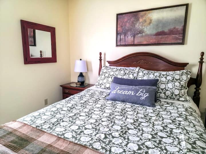 Enjoy this warm and inviting bedroom—complete with a cozy queen bed, peaceful views, and a private ensuite. Perfect for couples seeking a quiet, romantic retreat in the mountains or separate sleeping area for kids.