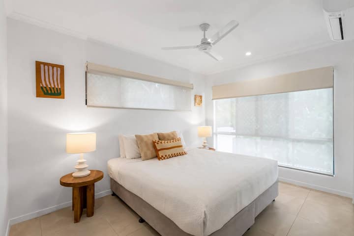 Recharge in the second bedroom, offering a king bed and soothing neutral styling for a restful night's sleep.