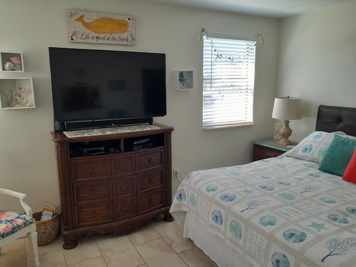King size bed and The TV swivels so that you can watch it from the couch, the bed or anywhere in the room. 