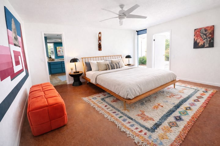 Queen bed with luxurious sheets and pillows with attached bathroom