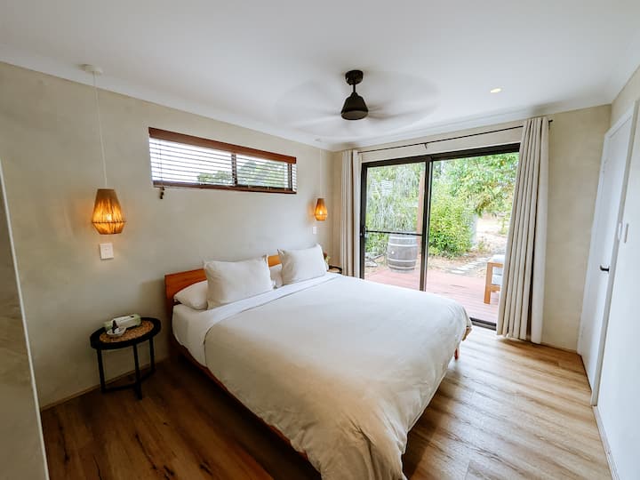Step into serenity as your bedroom opens up to a private deck. Sink into the comfort of a king-sized bed with soft flax linen, complete with Cloud Collection king-sized pillows & mattress topper. Relax in this cozy retreat after a day of adventure.