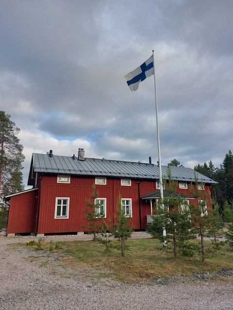 Large log house in the middle of nature close to services