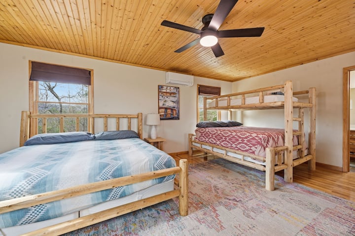 Loft area has a king size bed and a bunk bed that has a queen bed on the bottom and twin bed on top