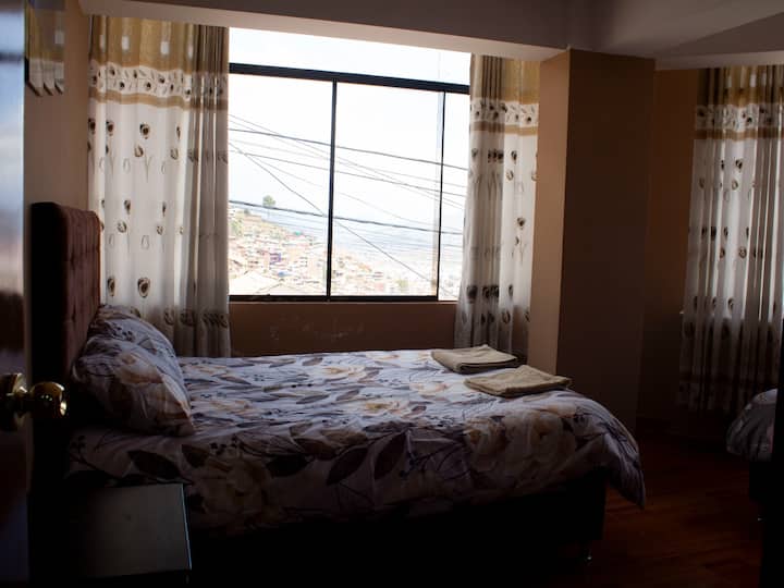 Chumba cha watu 3 chenye magodoro ya starehe, mifarishi ya joto na madirisha makubwa ambayo unaweza kushuhudia mandhari ya jua ya ajabu ya jiji letu la kifalme.