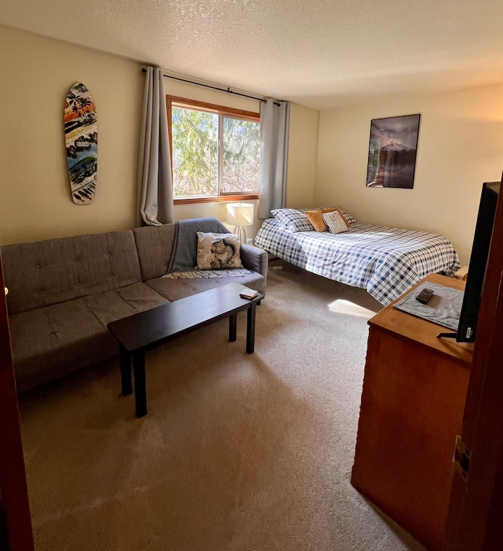 Playful double bed room with smart tv, double futon couch (with provided bedding), side table, dresser and beautiful views of Huckleberry Mountain.
