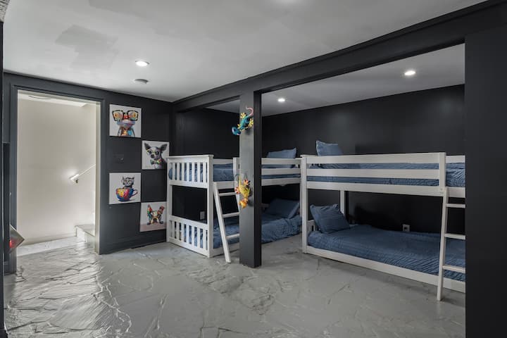 Game room sleeping space with two sets of bunk beds; perfect for kids, teens, or extra guests.
