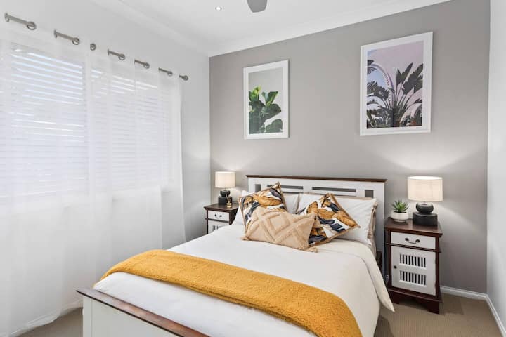 The light and airy second bedroom offers a queen-size bed, with mirrored built-ins creating a sense of spaciousness.