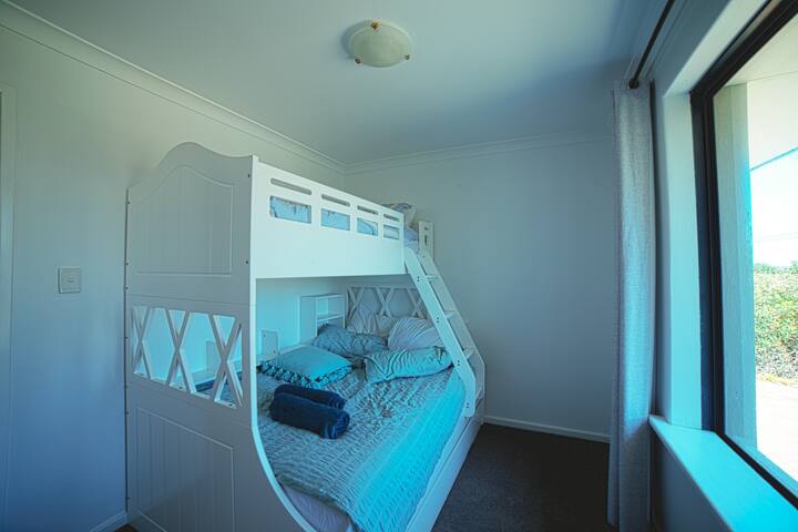 Triple bunk (double and a single above), wall fan and double window blinds (block out and light diffusing)