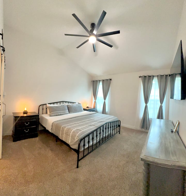 Master bedroom

Single King Bed
55" Roku Smart TV
USB Outlet on window side night stand and easy access to plug behind the bathroom side.