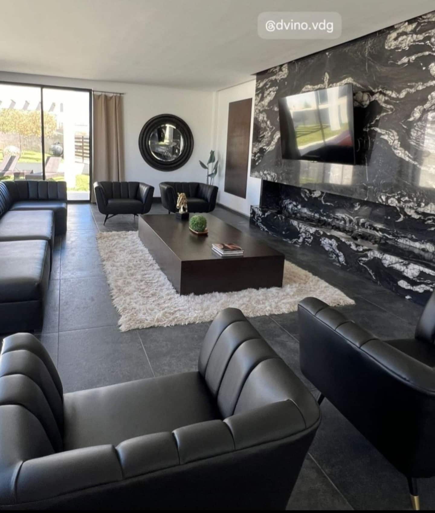 The lounge, with leather sofas and a marble wall