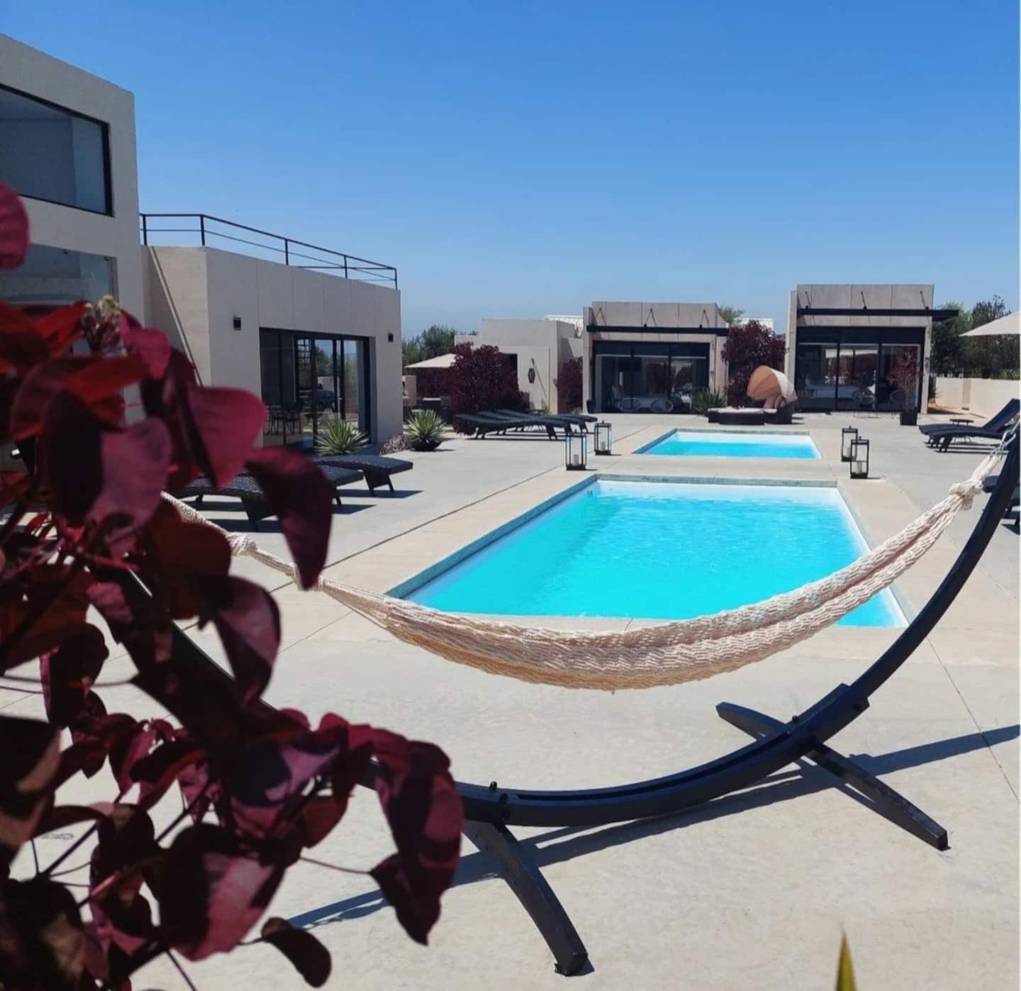 A hammock beside the pools