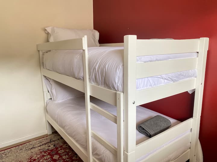 For the littlies, this new fun addition allows for larger families to enjoy the deep south. This room doubles as the office with a desk and chair where the photographer is standing.