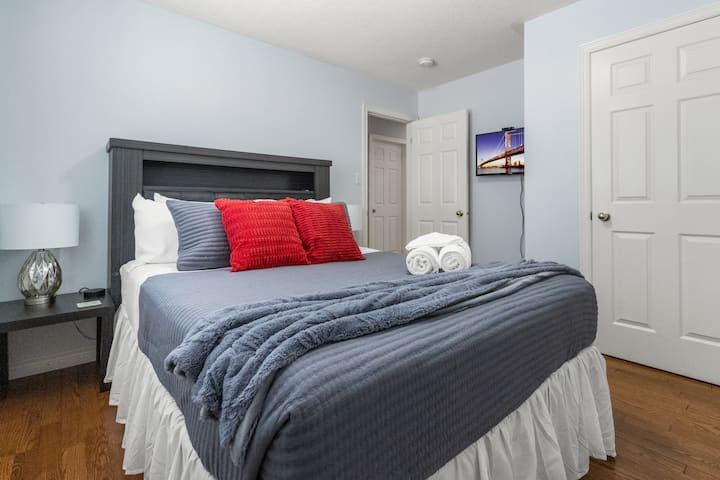 Another queen bedroom — cozy, clean, and its own little corner of the house with TV.