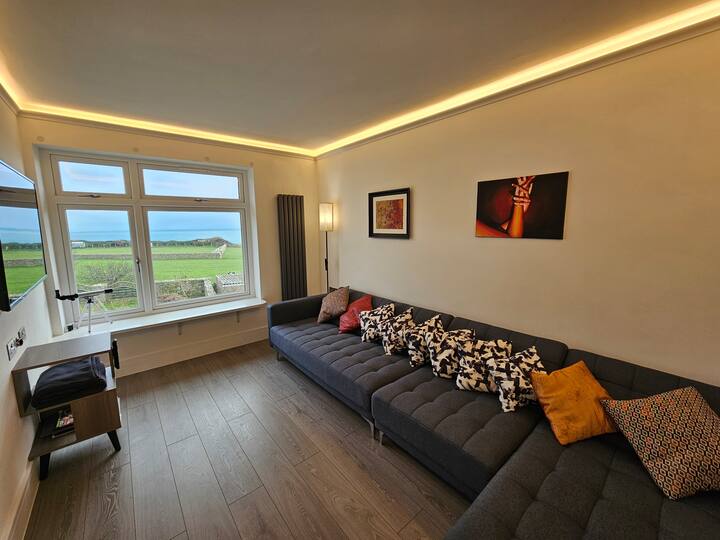 You have amazing views from the upstairs lounge, which captures the east side of Portland. Green fields and blue coastine. If you wake up early enough you will capture the amazing morning sunrise.

There is a comfortable L-shaped sofa to relax on.