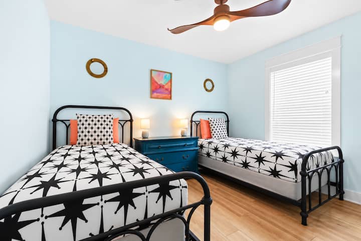 The double twin beds of our first floor bedroom is perfect for kids to share, an inflatable mattress is also available in the closet. The spacious dresser provides lots of storage for clothes, and each bed has it's own bedside lamp.