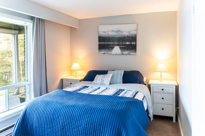 Queen bedroom on the lower level overlooking the water.