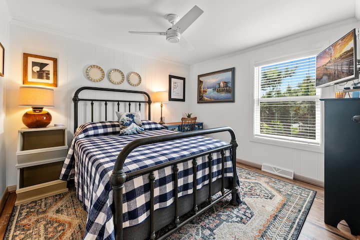 East-Full Bedroom with desk, ceiling fan, TV, and large private closet.