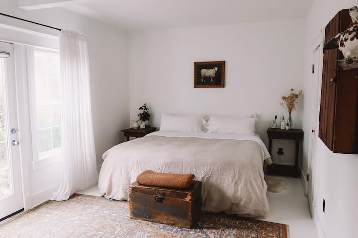 The Garden Bedroom is the master space in this home.  The trickling pond and the rich morning light is ever-present.  Sleep like a king on the large bed, steeped in our purest white intentions.  We envision this space as a cloud drifting carelessly.