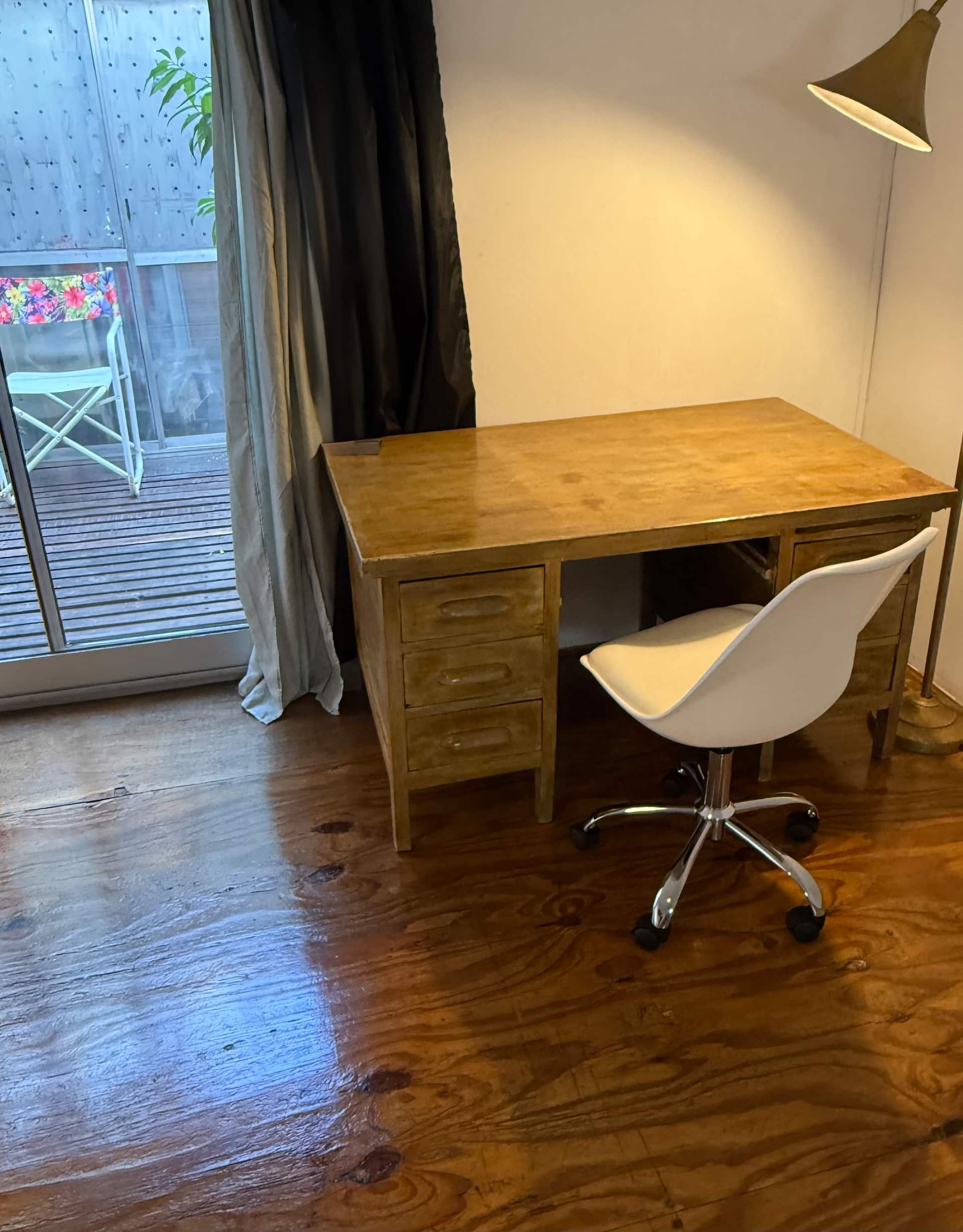 A warm and comfortable duplex studio with a deck and AC